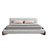 Modern oat latte bouclé upholstered bed with solid wood legs and FSC-certified timber slats in a luxury bedroom